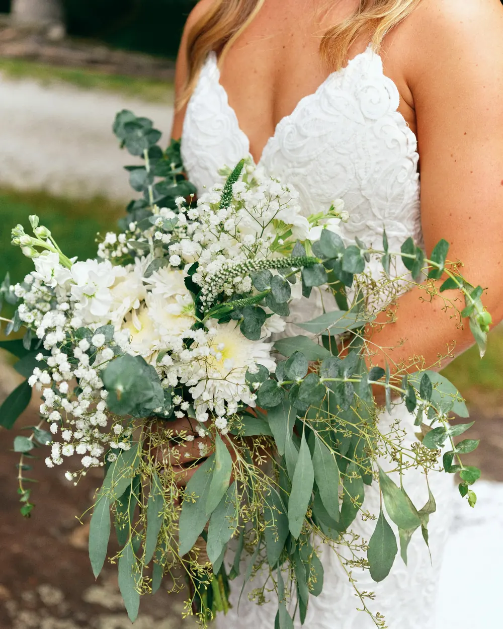 A bride holding a wild bouquet