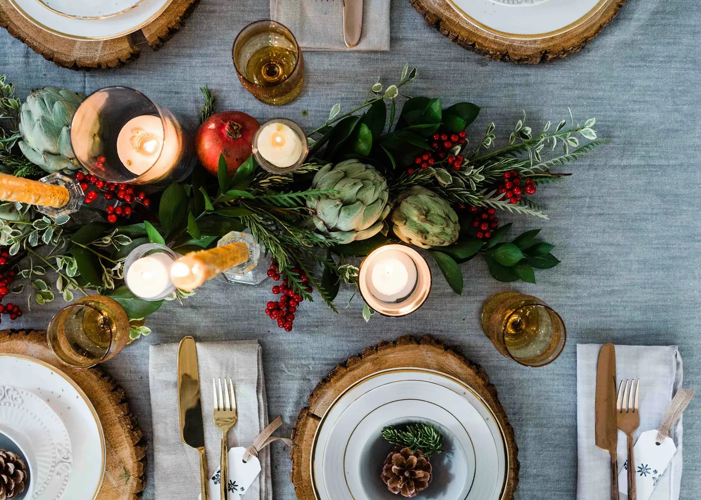 A wedding table set with candles and greenery